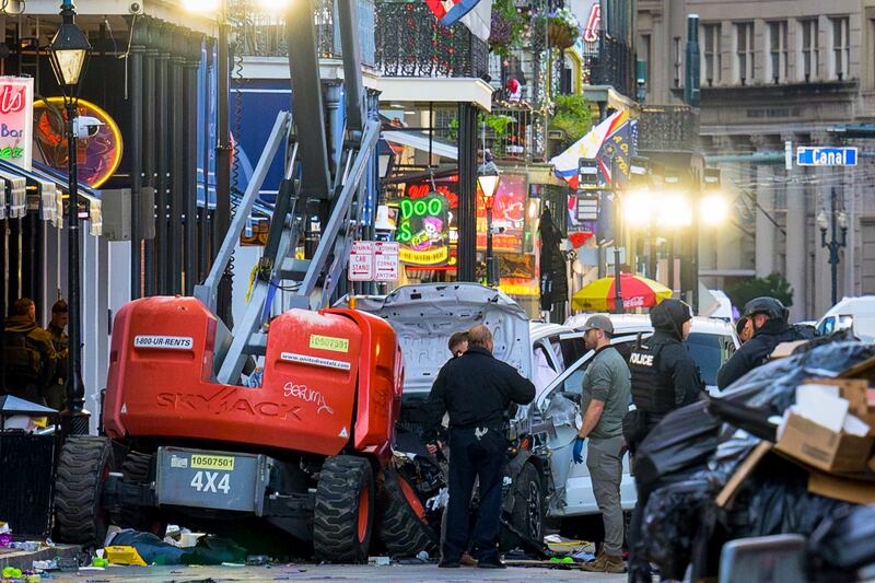 Police investigators surround a white truck that crashed into a work lift in the French Quarter of New Orleans, Louisiana. Photograph: Matthew Hinton/AFP/Getty