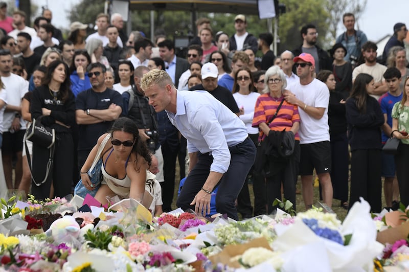 People lay flowers at Bondi Pavilion after two attackers opened fire near a Hanukkah celebration at Bondi Beach, killing 15 people. Photograph: Izhar Khan/Getty Images