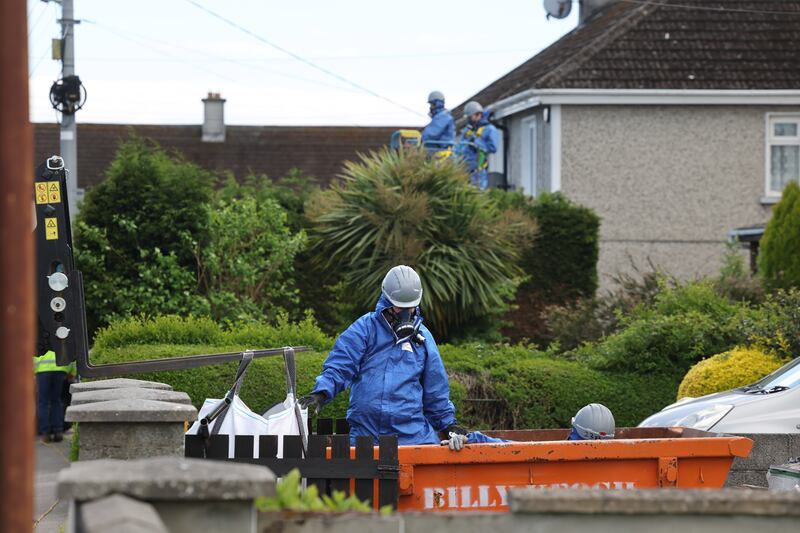 Workers clean potential asbestos residue around houses opposite the Tycor Business Centre. Photograph: Dara Mac Dónaill
