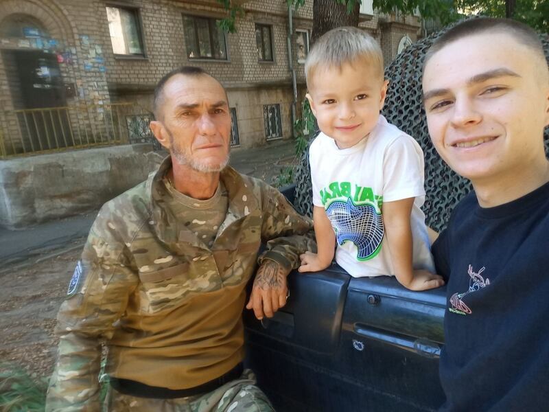 Oleksandr Yurychko with his two younger sons, Ihnat and Rinat, who are refugees in Latvia