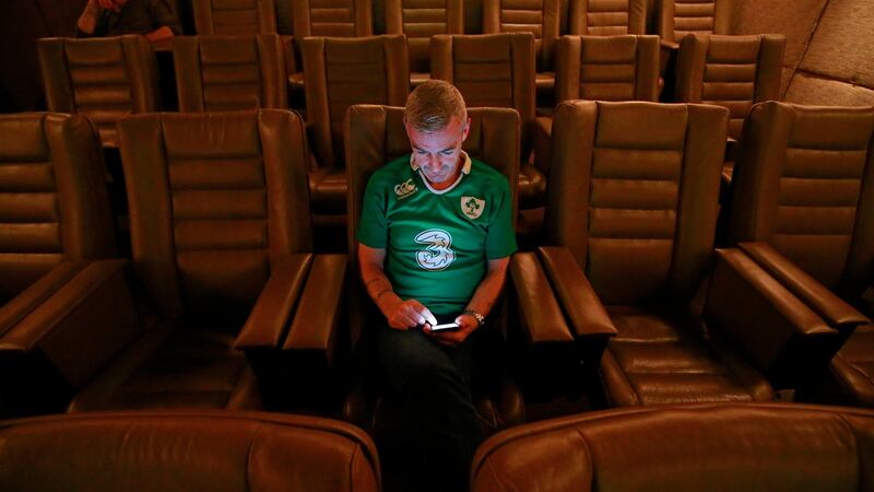 A Dublin Simon Community service user in the cinema at Brooks Hotel on Drury Street, Dublin, gets ready  for the Ireland game against Scotland in the Rugby World Cup on Sunday.  Photograph: Nick Bradshaw