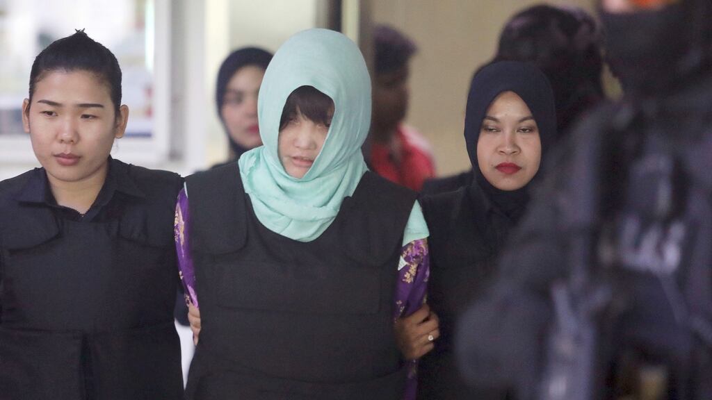 Vietnamese national Doan Thi Huong, centre, is escorted by police as she leaves the court in Shah Alam, Malaysia. Photogrtaph: AP Photo