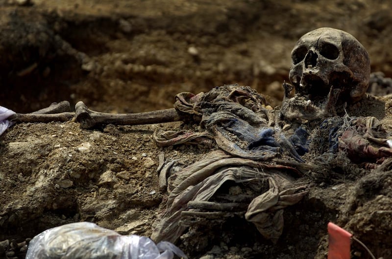 The body of a victim of the Srebrenica massacre, the worst ethnically motivated mass murder on the continent since the second World War, in a mass grave in Budak, Bosnia. Photograph: Andrew Testa/The New York Times
                      