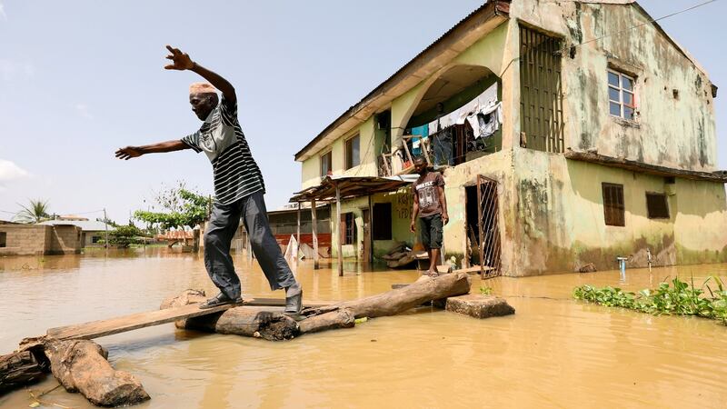 A man makes his way through flood waters in Kogi State, Nigeria. Photograph: Afolabi Sotunde/Reuters