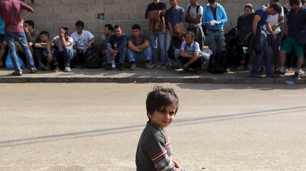 A child sits in front of other migrants waiting for the lunch offered to them for the celebration of Eid-al-Adha in the village of Miratovac, south Serbia. Photograph: Hazir Reka/Reuters