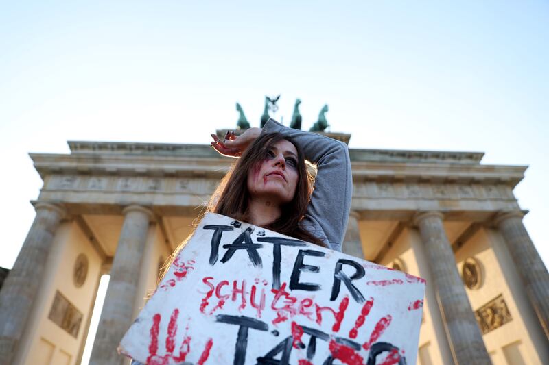 A protester holds a sign reading 'Täter schützen Täter' ('Perpetrators protect perpetrators') at a demonstration in support of actress Collien Fernandes, protesting violence against women, in Berlin, Germany. Photograph: Maryam Majd/Getty