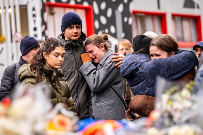 Mourners gather near Le Constellation bar, where a fire broke out during New Year's celebrations. Photograph: Maxime Schmid/AFP/Getty Images