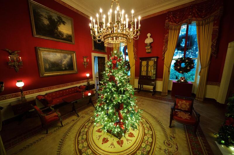A Christmas tree and decorations in the Red Room of the White House. Photograph: Drew Angerer/Getty