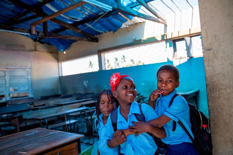 Children attend school in a classroom covered by plastic sheets at the Mulheres de Macombe Primary School in Beira, Mozambique.  One year after cyclone Idai made landfall, there are still 2,5 million people in urgent need of assistance. Photograph: Karel Prinsloo/UNCDF/AFP via Getty
