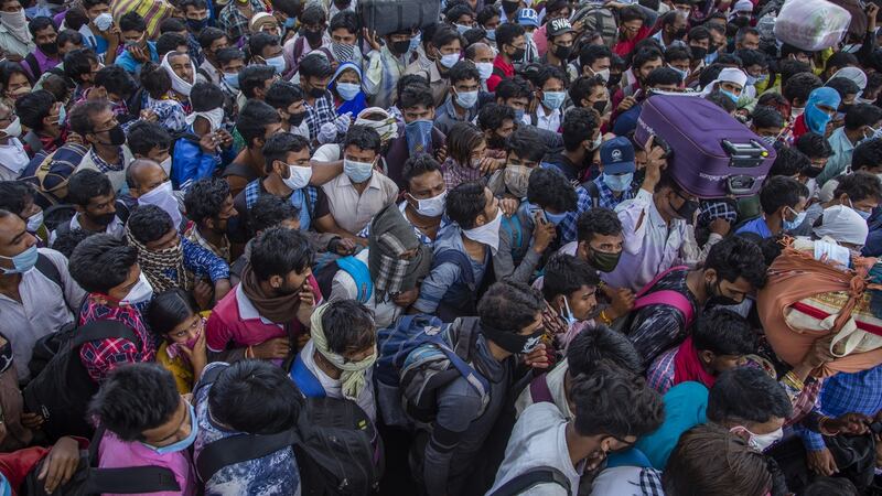 Indian migrant workers and labourers try to board buses near New Delhi on Sunday. Photograph:  Yawar Nazir/Getty Images