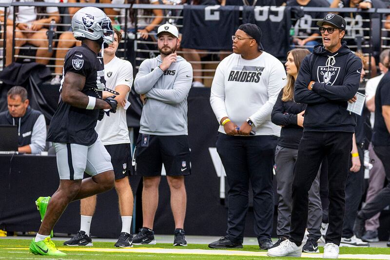 Tom Brady (last on right) yells encouragement to Raiders players at a training match. Photograph: LE Baskow/Las Vegas Review-Journal