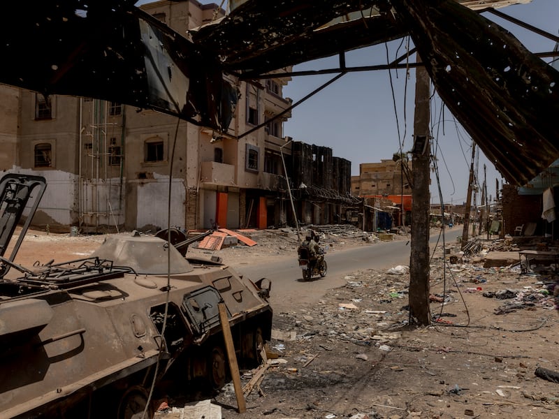 Sudanese soldiers drive through a destroyed market in Sudan’s capital, Khartoum. Photograph: Ivor Prickett/New York Times