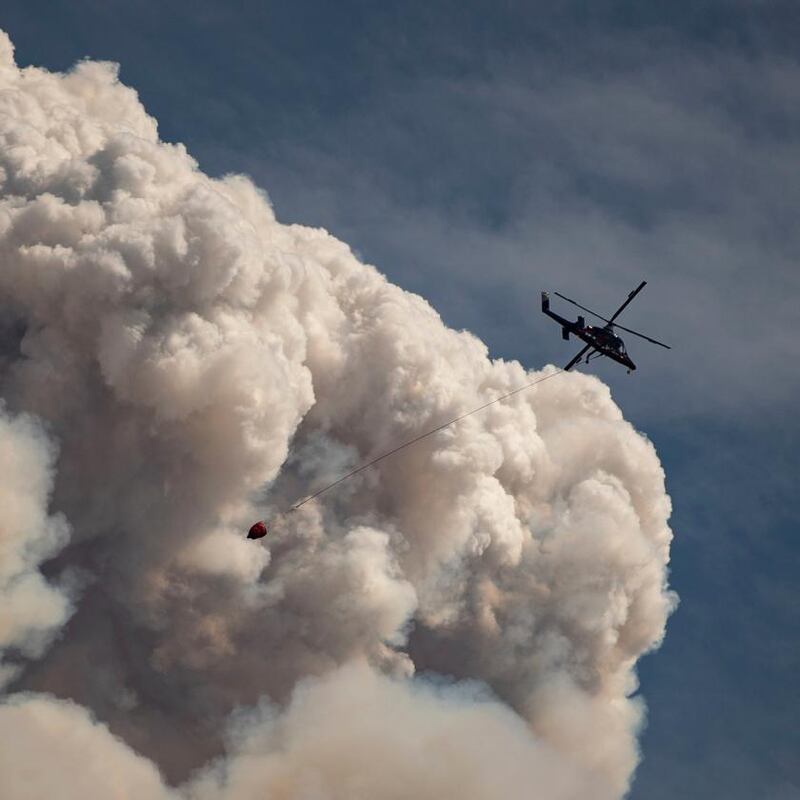 Lytton fire: a helicopter carries a water bucket above the wildfire on Sunday. Photograph: Darryl Dyck/Canadian Press via AP