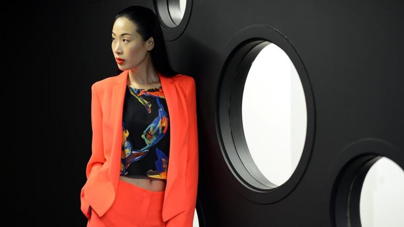 Model Yomiko Chen wearing a bright coral jacket and trousers by Tara Jarmon, at the launch of Arnotts Spring Summer 2015 collections , in Dublin. Photograph: Eric Luke / The Irish Times