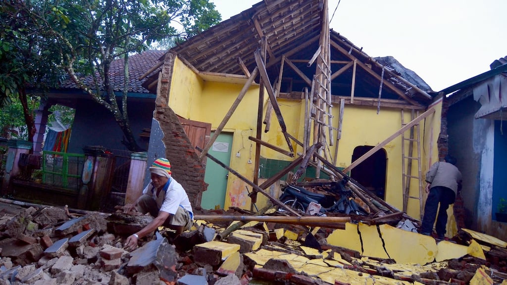 An Indonesian man inspects his property after a 6.5-magnitude earthquake, in Sumelap village, Tasikmalaya, West Java, Indonesia. Photograph: Daeng/EPA