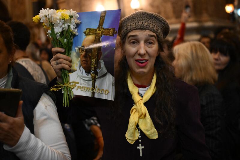 A woman holds a picture of late Pope Francis during a mass at the San Jose de Flores Basilica in Buenos Aires on Monday. Photo: Getty Images       