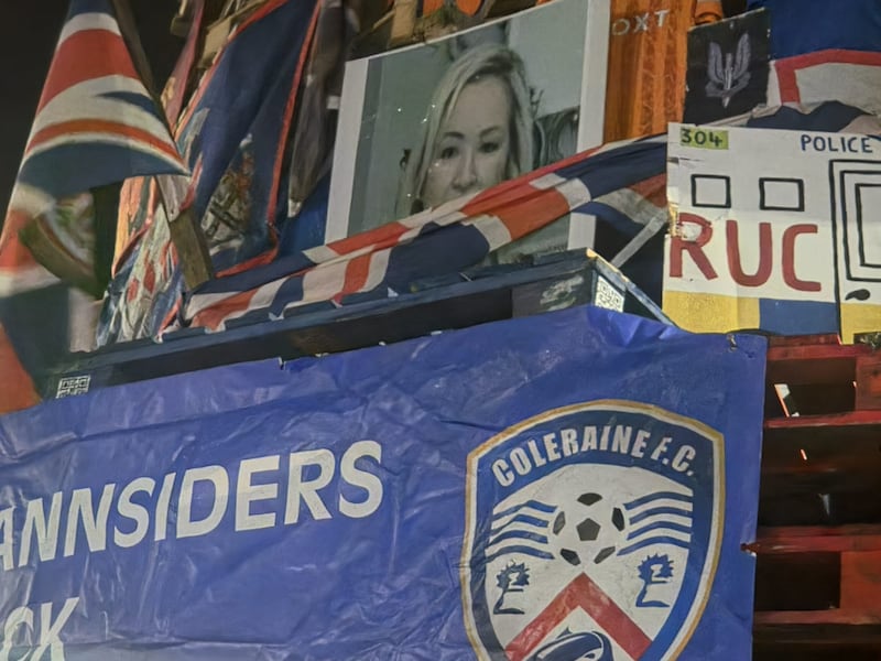 Symbols including a photograph of First Minister Michelle O’Neill, British flags and a Coleraine FC banner on a bonfire in the Bogside in Derry on August 15th.