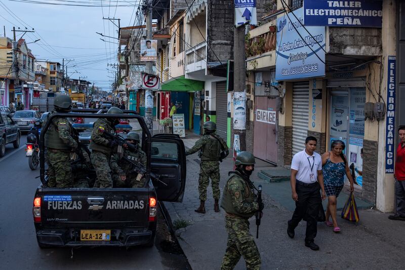 Soldiers patrolling Durán, a suburb of Guayaquil, Ecuador, which is dominated by groups linked to drug trafficking. Photograph: Victor Moriyama/The New York Times
                      