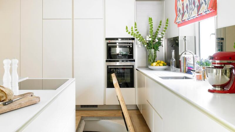 A basement hatch  set into the kitchen floor provides room for a wine cellar.