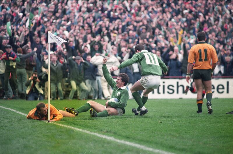 Gordon Hamilton celebrates a try to the despair of Rob Egerton (left) and David Campese of Australia. Photograph: Peter Thursfield