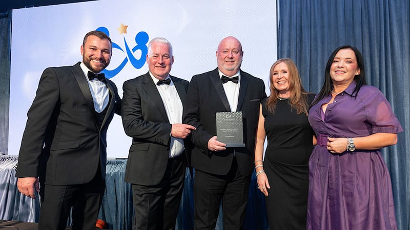 Aidan Walker, director of key accounts at ISS Ireland, presents the health & safety excellence award - warehousing to United Hardware team