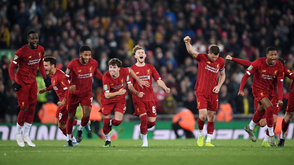 Liverpool players celebrate the penalty shootout victory over Arsenal in the fourth round of the Carabao Cup at Anfield. Photograph: Laurence Griffiths/Getty Images