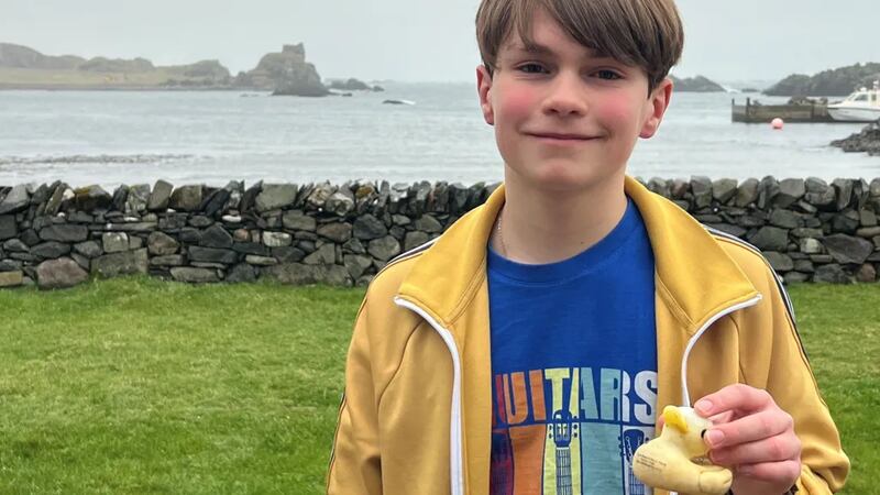 Emil Wrede with the plastic duck he and his sister Hannah found buried in mud on Lagulvin Bay. Photograph: Daniel Wrede