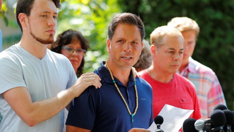 Don Damond is comforted by his son Zach Damond as he speaks to the media about his fiance, Justine Damond. Photograph:  Adam Bettcher/Reuters