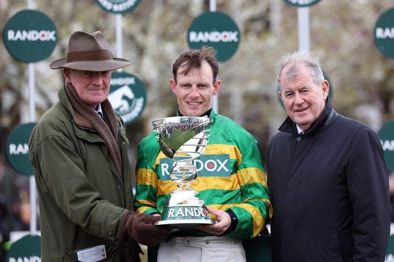 Jockey Paul Townsend (centre), trainer Willie Mullins (left) and owner of horse I Am Maximus, JP McManus celebrate with the trophy after victory in the Grand National. Photograph: Matt Alexander for the Jockey Club/PA