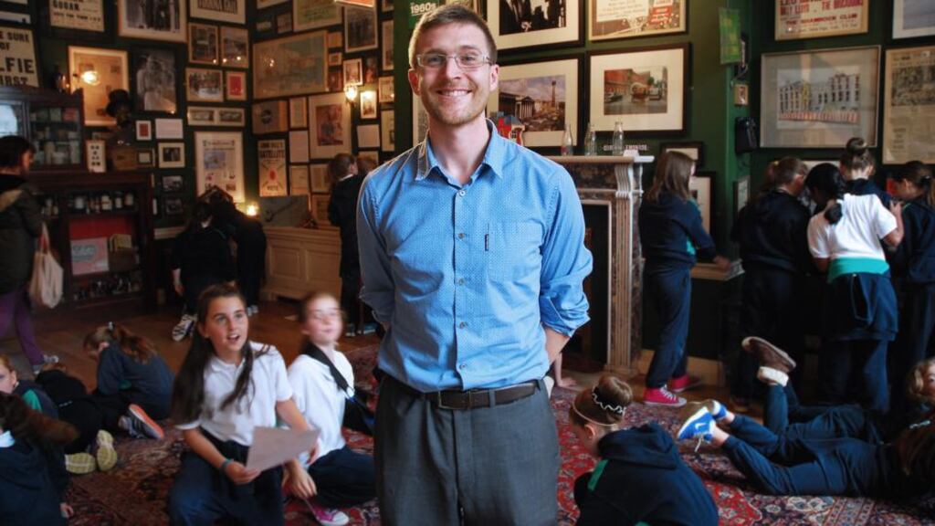 Curator Mark O’Neill at the Little Museum of Dublin on St Stephen’s Green with pupils from St Pius X Girls’ National School. Photograph: Simon O’Connor