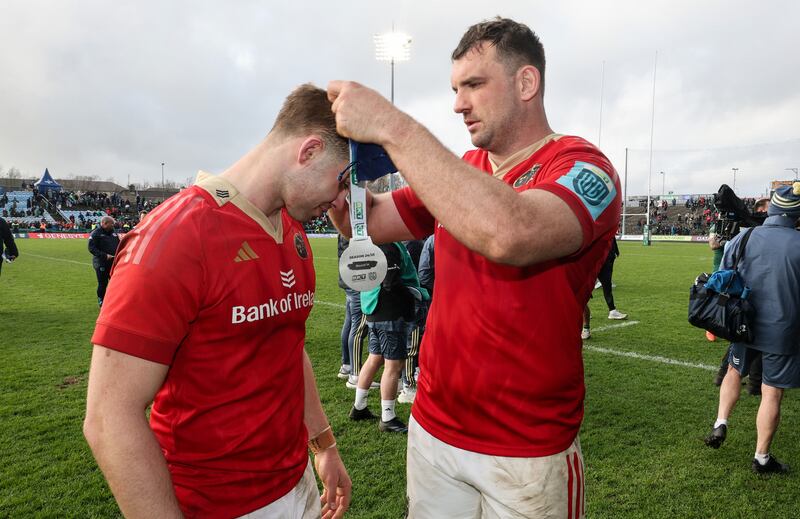 Tadhg Beirne presents Jack Crowley with his Player of the Match award after Munster's win over Connacht at MacHale Park. Photograph: Billy Stickland/Inpho