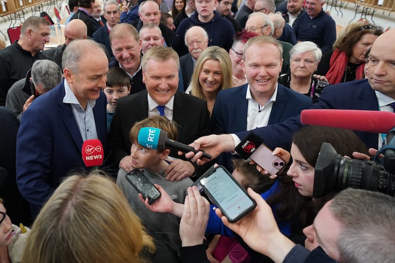 Fianna Fail leader Micheal Martin congratulates Seamus McGrath (right) as he celebrates with his brother Michael McGrath, after being elected in Cork South Central in last year's general election. Photo: Jacob King/PA Wire
