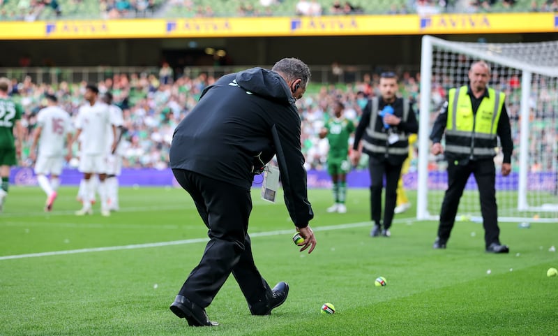Security staff remove tennis balls with the words 'Stop the Game' emblazoned on them during last month's friendly between Ireland and Qatar at the Aviva Stadium. Photograph: Ryan Byrne/Inpho