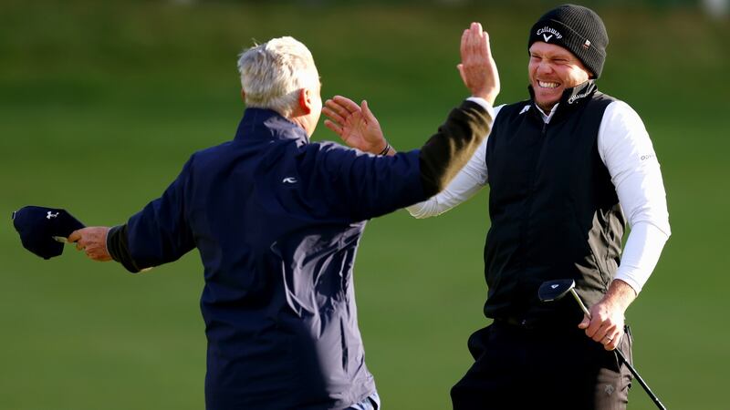 Danny Willett celebrates with amateur partner Jimmy Dunne after winning. Photo: Richard Heathcote/Getty Images