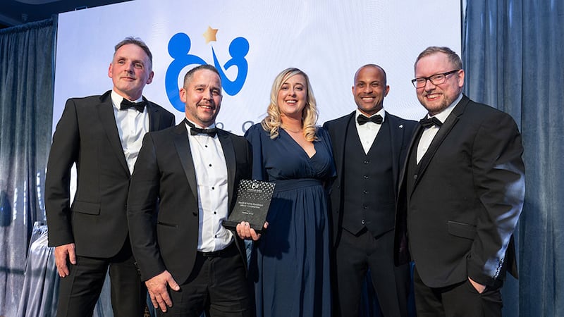 Tony Fox, associate director of Ashview Consultants, presents the health & safety excellence award - construction to Bretland Group team