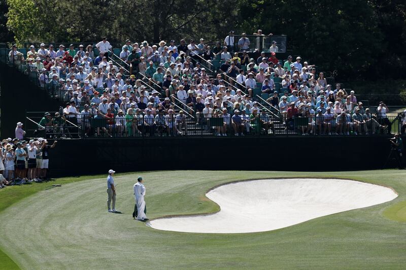 Rory McIlroy of Northern Ireland (L) looks at his chip shot on the fourth green in Round 4 of the 2026 Masters tournament in Augusta, Georgia, USA, 12 April 2026. Photograph: Erik S Lesser/EPA
