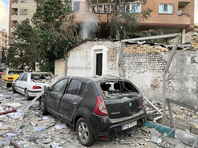 Debris from an apartment building is seen on top of parked cars after a strike in Tehran, Iran, early on Friday. Photograph: AP