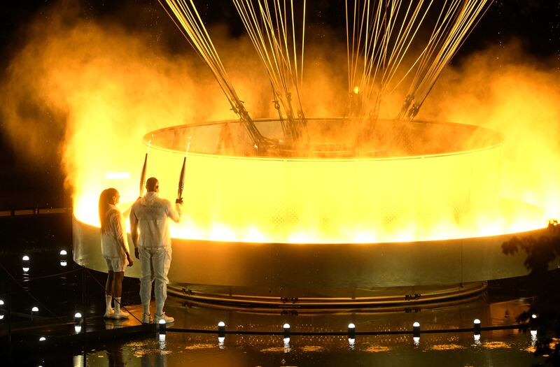 Paris 2024 Olympic Games: Torchbearers Teddy Riner (R) and Marie-Jose Perec light up the Olympic cauldron. Photograph: Xia Yifang/Getty Images