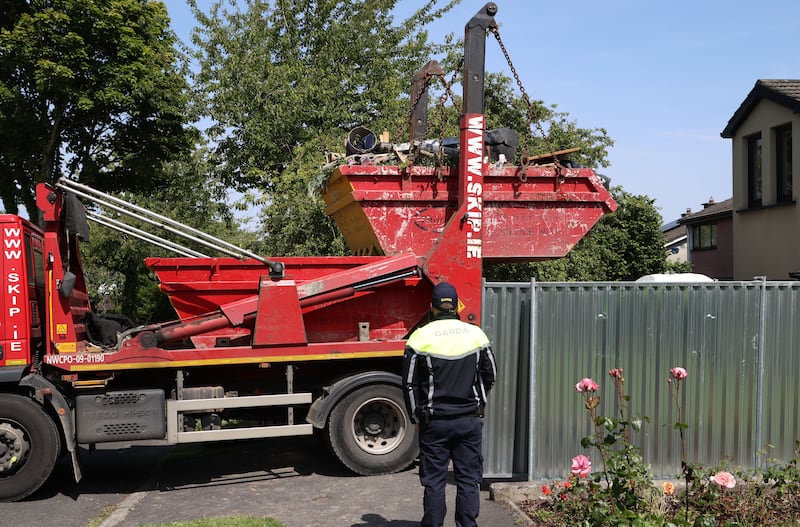 Gardaí remove a skip during their search on a house at Monastery Walk in Clondalkin in the investigation into the murder of Annie McCarrick, who disappeared in 1993. Photograph: Colin Keegan/Collins