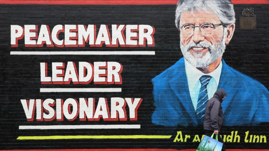 A man walks past a mural Gerry Adams, painted after the Sinn Féin president’s arrest last week, on the Falls road. Photograph: Reuters
