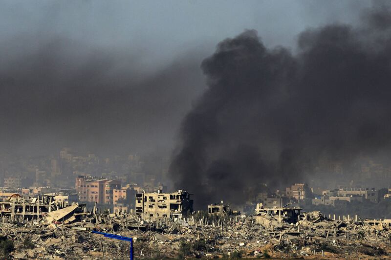 A picture taken from southern Israel near the border with the Gaza Strip shows smoke rising from buildings still smouldering after being hit by Israeli strikes before the start of a four-day truce. Photograph: JOHN MACDOUGALL/AFP via Getty Images