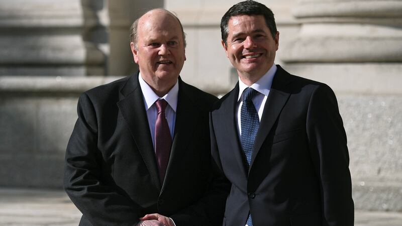 Michael Noonan and Paschal Donohoe shake hands on the steps of Government Buildings. Photograph: Reuters/Clodagh Kilcoyne