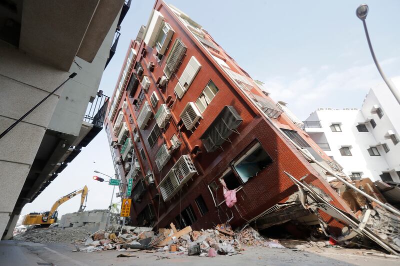 Debris surrounds a tilted building in Hualien (Chiang Ying-ying/AP)