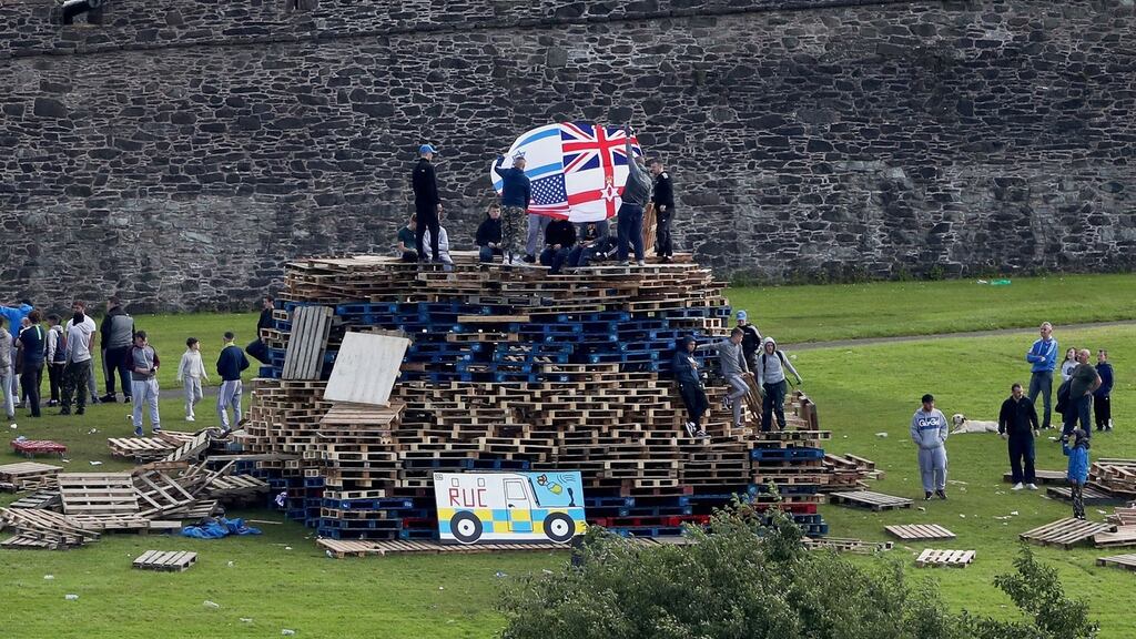 People build a bonfire in the bogside area of Derry, which is traditionally torched on August 15 to mark a Catholic feast day celebrating the assumption of the Virgin Mary into heaven. Photograph: Niall Carson/PA Wire