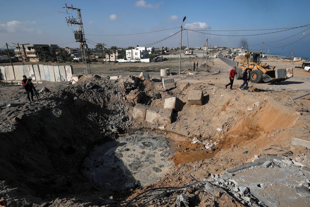 Palestinians inspecting the site of an air strike in Deir al Balah in central Gaza Strip on Wednesday. Photograph: Anas Baba/AFP via Getty Images