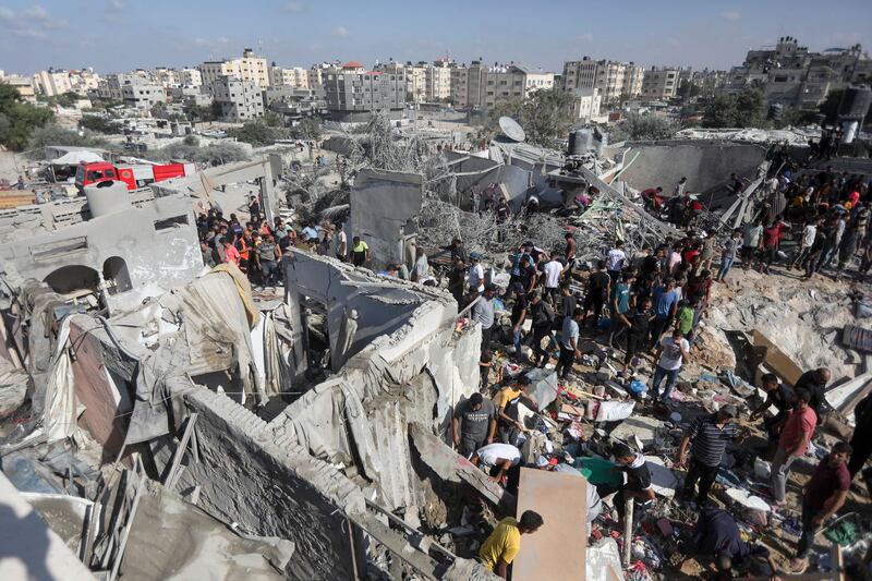 People inspect the damage to a family home which was destroyed during Israeli air strikes, in Khan Younis, in the southern Gaza Strip. Photograph: Yousef Masoud/New York Times