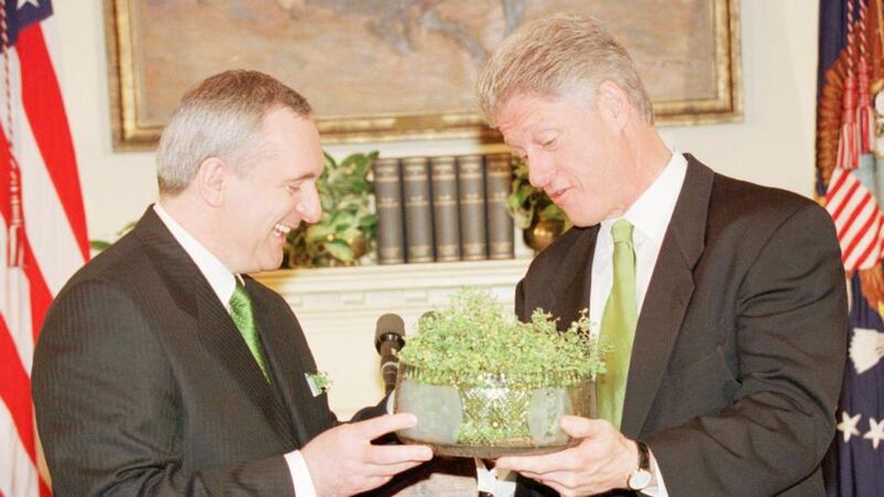 Former taoiseach Bertie Ahern presents then US president Bill Clinton with a bowl of shamrock in 1998. Photograph: Win McNamee/Reuters