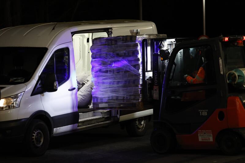 A van is loaded by a forklift with newspapers late in the night. Photograph: Nick Bradshaw