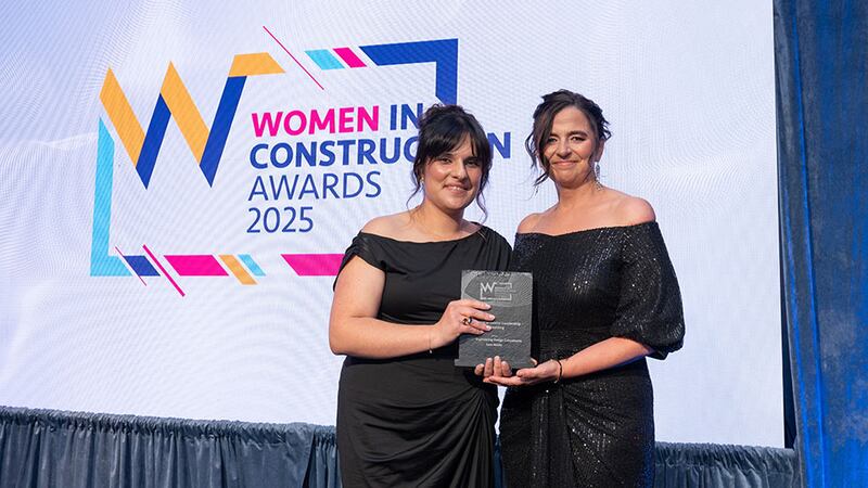 Carolina Concialdi, training and development manager at Walls Construction, presents the excellence in senior leadership - consulting award to Sara Steele, EDC - Engineering Design Consultants