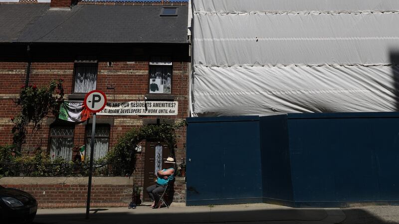 73-year-old 
  Tommy Byrne, a retired Fás employee, lives with his wife at one end of this row. He has a big off-white sign that reads: “Where are our residents’ amenities?” Photograph: Nick Bradshaw
